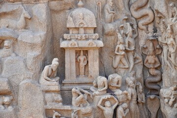 Descent of the Ganges: A giant open-air rock bas relief carved on two monolithic rocks in Mahabalipuram. It contains sculptures of animals, God, people and half-humans carved in the rock relief.