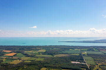 Innisfil water front beach shore line with farm land and lake simco in view 