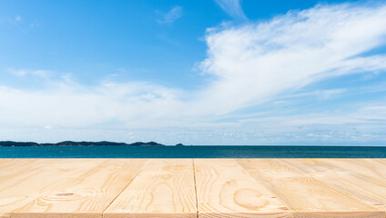Wooden table for a picnic and a beautiful sea with blue sky background