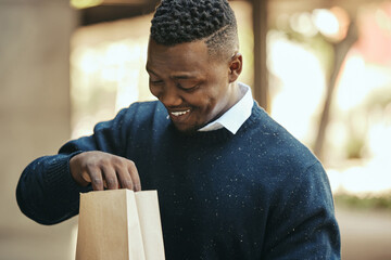 Food, delivery and happy business man on a lunch break outside, smiling while opening a brown paper bag. Hungry worker satisfied with meal order, ready to enjoy a snack. Male impressed by deliver app