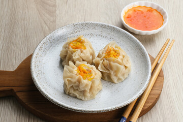 Delicious Dim Sum, home made chinese dumplings served on plate, with sauce and chopstick
