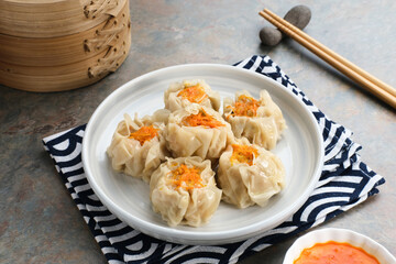 Delicious Dim Sum, home made chinese dumplings served on plate, with sauce and chopstick