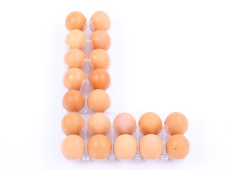 tray of raw eggs isolated on a white background