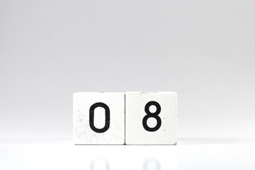 White wooden block with number 08 with reflection isolated on white background