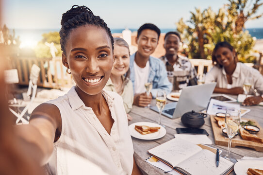 Brunch, selfie and friends at a beach restaurant after successful teamwork and business collaboration. Wine, champagne glasses on lunch table and happy global marketing group celebrate in luxury