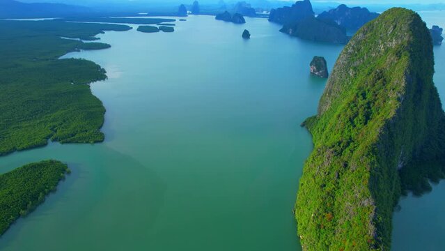 Drone is flying over Phang Nga Bay, among Phang Nga spectacular landmarks is the iconic many limestones peaks. Exotic sea view of tropical landscapes paradise. Samed Nang Chee, Phang Nga, Thailand.
