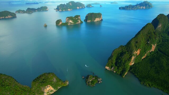 4K : Aerial view from a drone flying over Phang Nga Bay, beautiful many limestones peaks islands with its known the world over. (Samed Nang Chee), Phang Nga Province, Southern Thailand. Tropical sea
