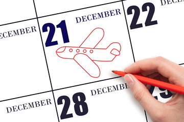 A hand drawing outline of airplane on calendar date 21 December. The date of flight on plane.