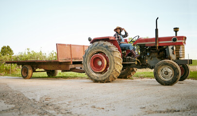 Farm, tractor and agriculture with happy woman farmer driving a vehicle on farm for sustainability,...