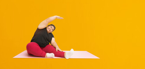 Asian fat woman workout isolated on yellow background, Clipping paths for design work empty free...