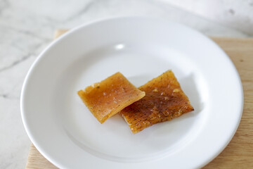 Fried pork skin on a white plate. Pig food culinary cuisine.