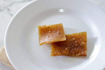 Fried pork skin on a white plate. Pig food culinary cuisine.