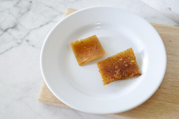 Fried pork skin on a white plate. Pig food culinary cuisine.