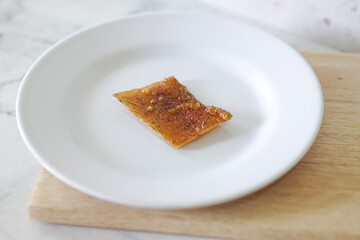 Fried pork skin on a white plate. Pig food culinary cuisine.