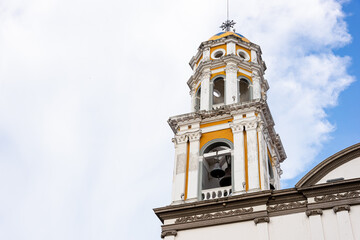 Fototapeta na wymiar Bell tower in the center of the park in the magical town of Comala in Colima, Mexico, white town, copy space