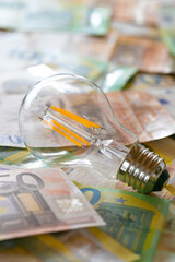 Electricity cost. light bulb on euro bills.Rising electricity prices in Europe.Crisis of energy...