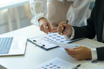 Business people present the work to the head of the department to acknowledge the company's performance, graph, chart, marketing, various financial statement in the company, quarterly result.