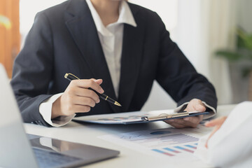 Business people present the work to the head of the department to acknowledge the company's performance, graph, chart, marketing, various financial statement in the company, quarterly result.