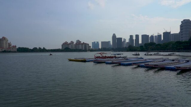 Scenic view of Kallang Basin, dragon boats at the pier against Singapore cityscape