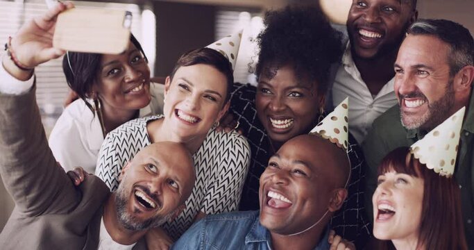Friends at a house or birthday party, take a selfie together in celebration. Diversity and a funny face on a phone camera, a group of happy men and women having fun at a social event with party hats.
