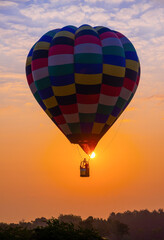 Silhouette of ballon rising at the sunrise, balloon silhouette with sunrise over the mountain