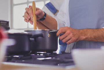 Couple cooking together in the kitchen at home