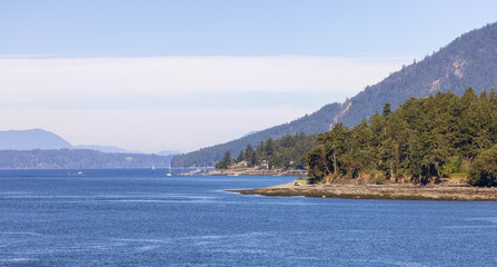 Fototapeta premium Canadian Landscape by the ocean and mountains. Summer Season. Gulf Islands near Vancouver Island, British Columbia, Canada. Canadian Landscape.