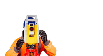 A builder in a blue helmet, orange reflective hi-visibility fleece and safety gloves on white background with space for text using modern surveying equipment.  