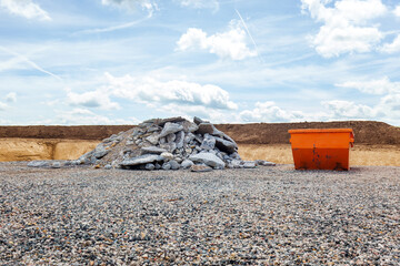 construction site, building site and rubble container, concrete debris piles on the ground. pile of...