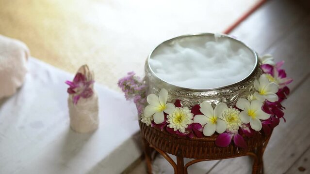 Spa massage wellness decorations setting on wood table. Thai spa massage traditional compress for hot massage and spa relaxing treatment of office syndrome. Massage for health concept.