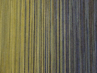 縦縞の黄色と青系の色合いの布地のテクスチャー