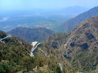 Beautiful mountain range with birds flying over the top in bright sunny day in Katra, Jammu Kashmir, Vaishno Devi