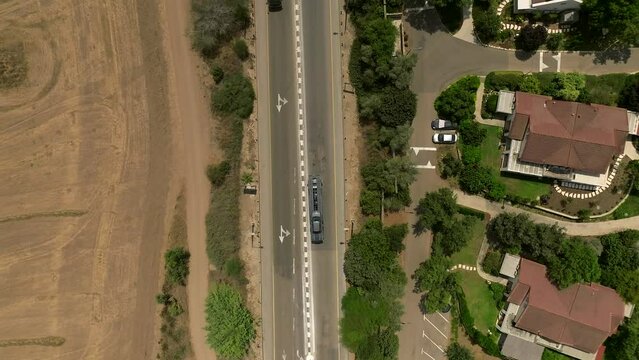 Tow truck carrying a single car on a rural highway, Aerial follow footage.