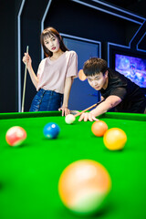 couple playing pool