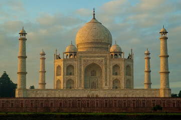 The Taj Mahal 'Crown of the Palace', is an Islamic ivory-white marble mausoleum on the right bank of the river Yamuna in the Indian city of Agra. It was commissioned in 1632 by the emperor Shahjahan.