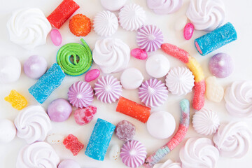 Flat lay with colorful, festive sweets, cookies, candies, marshmallow on white background. Birthday party.