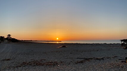 Fototapeta na wymiar orange sunrise cloudless sky on island of Djerba