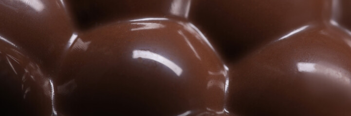 Closeup of bar of airy aerated milk chocolate background