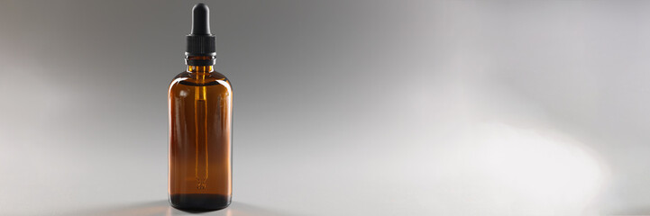 Closeup of glass brown jar with cosmetic serum