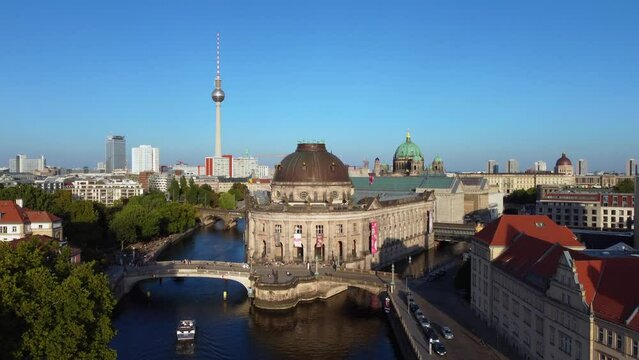 Subway, ICE train, 2 boats under bridge.
Gorgeous aerial view flight pedestal up drone footage
of berlin Bode Museum island at summer day sunset July 2022. P. Marnitz 4k Cinematic view from above