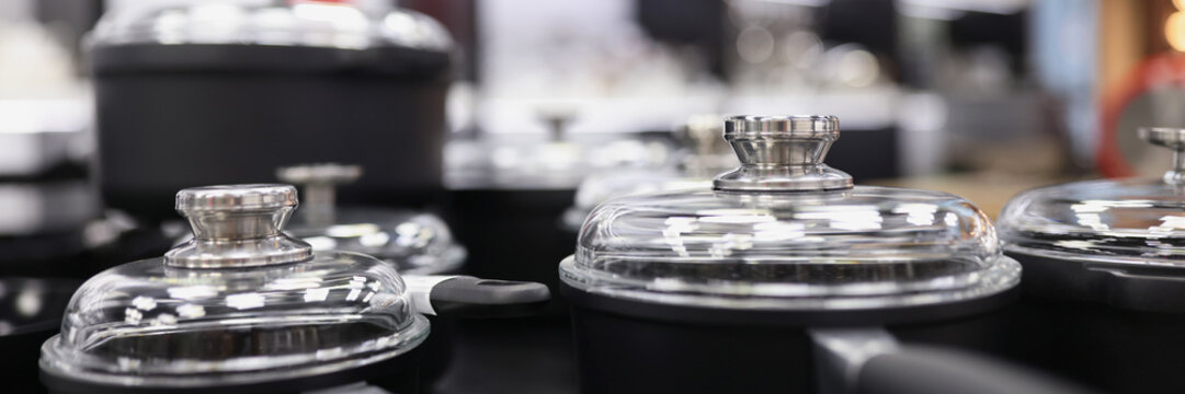 Set of pots and pans in store closeup