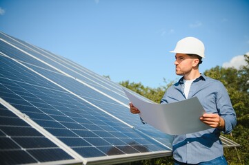 Solar power plant. Engineer on a background of photovoltaic panels. Science solar energy.