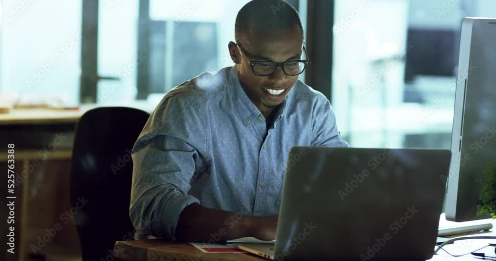 Fototapete IT man working on business with a laptop late at work, reading email on computer with smile and success on internet in a dark office. Corporate employee being creative on web at tech company