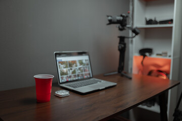 Desktop of the content creator with the laptop and red cup