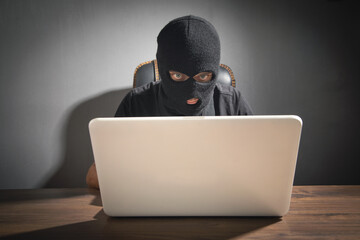  Hacker stealing information from the office computer. Hacking, Criminal