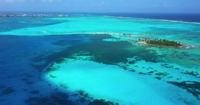 Drone footage flying over the blue water and reef of San Andres Island in Colombia. Capturing the surrounding islands Haynes Cay and El Acuario.