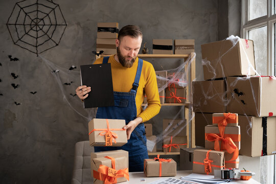 E-commerce business owner to confirm order and reviewing checklist of customer address before sent box of product by parcel post. Helloween sale