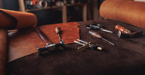 Concept background tailor shoes maker. Natural leather brown color with tools, copy space