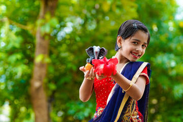 Cute indian little girl celebrating lord ganesha festival.