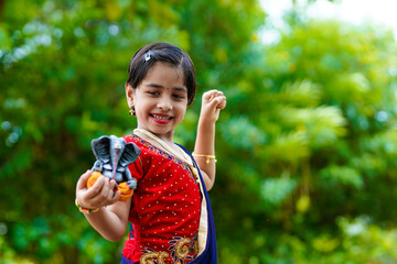 Cute indian little girl celebrating lord ganesha festival.